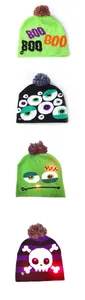 Variety of Halloween LED knit beanies featuring glowing skull and monster patterns with pom-poms.