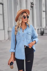 Detailed street style view of a light blue denim shirt with lapel and pockets