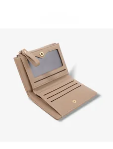 Internal view of beige bi-fold women's wallet showing multiple card slots and ID window