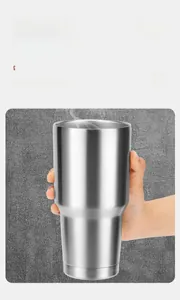 Detailed view of hand holding a large stainless steel vacuum insulated silver tumbler