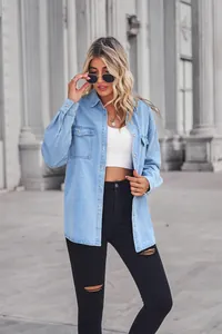 Model wearing light blue long-sleeved denim shirt with lapel collar and chest pockets