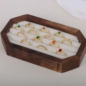 Detailed view of vintage French gold-plated adjustable rings in a wooden display box