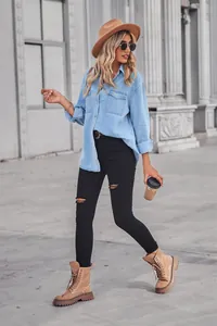 Model wearing a light blue denim shirt with dual pockets in a street style setting