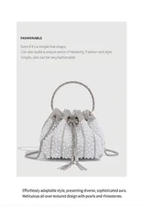 Close-up of elegant white pearl and rhinestone bucket bag with silver chain strap
