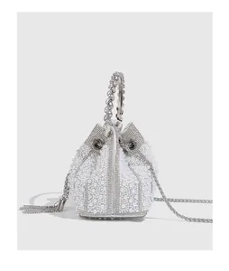 Detailed view of pearl and crystal encrusted evening bucket bag with silver tassel