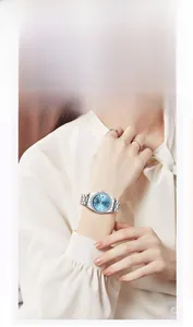 Close-up view of an elegant women's quartz watch with blue dial and diamond bezel