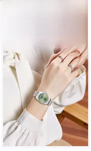 Elegant ladies quartz watch featuring a green dial and silver stainless steel strap