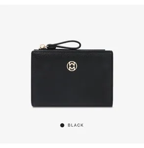 Minimalist black pebbled leather small wallet with circular gold logo detail front view