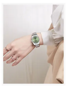 Elegant women's silver stainless steel watch with green dial and crystal bezel detail