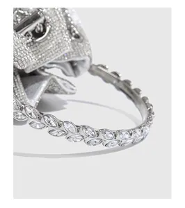 Detailed close-up of a sparkling rhinestone evening bag handle with marquise crystal leaf pattern