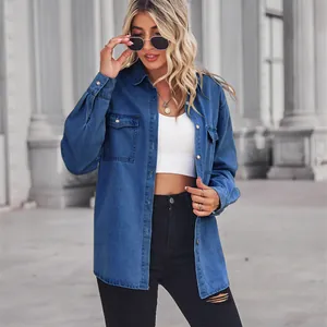 Women's blue denim shirt with lapel collar and long sleeves, worn over white crop top.