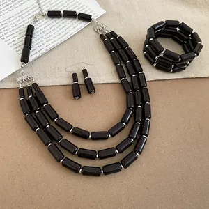 Elegant black bead jewelry set with multi-strand necklace, bracelet, and matching earrings
