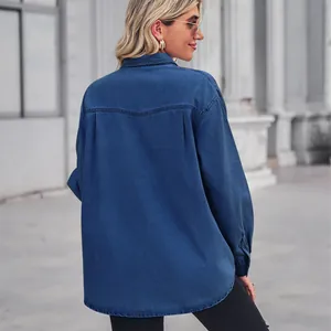 Back view detail of a classic deep blue long-sleeve denim shirt for women in outdoor