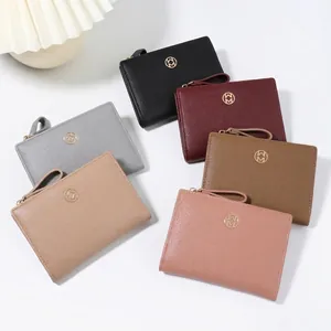 Minimalist multi-color bi-fold women's short wallets featuring elegant gold metal logos