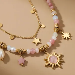 Elegant handmade colorful beaded necklace featuring a gold sun pendant and pink crystal beads