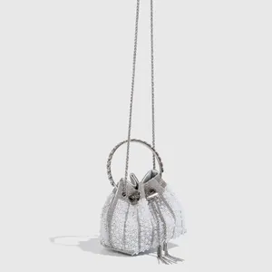 Elegant pearl and rhinestone evening bucket bag with metal handle and chain strap.