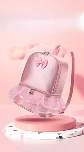 Detailed view of pink satin dance backpack with bow decoration and tutu lace trim.