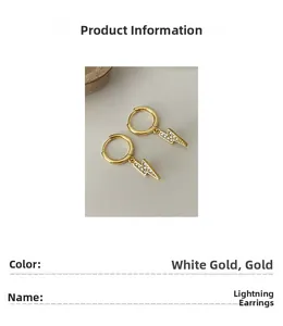 Close-up detail of gold lightning bolt hoop earrings with sparkling rhinestones
