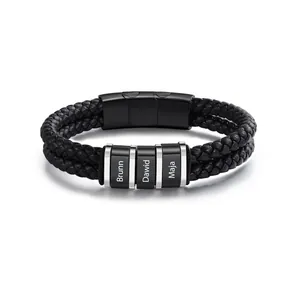 Close-up of personalized men's black braided leather bracelet with custom name engraving