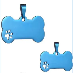 Detail of blue stainless steel bone-shaped pet ID tags with hollow paw print design