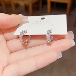 Detailed view of sparkling cubic zirconia small hoop earrings with polished silver finish