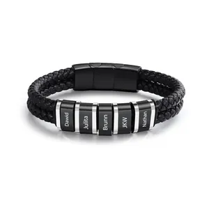 Close-up of personalized black braided leather bracelet with engraved name beads