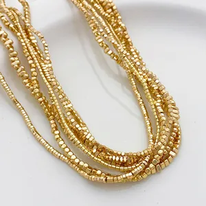 Vue macro détaillée de perles en hématite dorée pour la création de bijoux DIY.