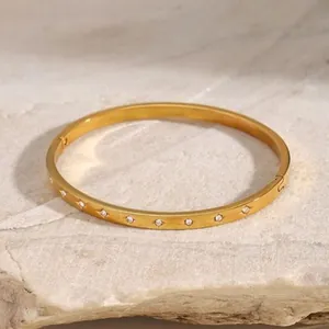 Minimalist gold-plated stainless steel bangle with zircon inlay and secure clasp closure