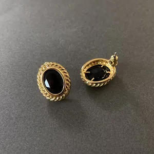 Vintage oval gold-toned earrings with faceted black gemstones and rope edge