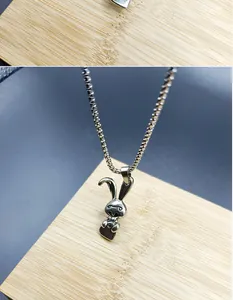 Macro view of a cute stainless steel bunny pendant on a durable box chain necklace.