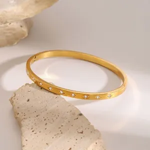 Elegant gold stainless steel bangle with zircon accents and a secure hinge clasp