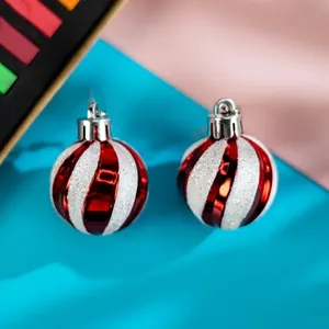 Festive red and white striped Christmas ball earrings with glitter detail