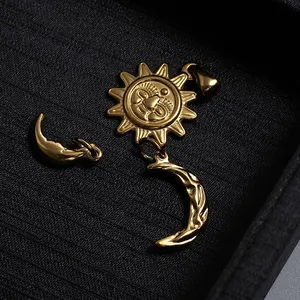 Detailed macro of gold plated stainless steel sun and moon celestial jewelry pendants