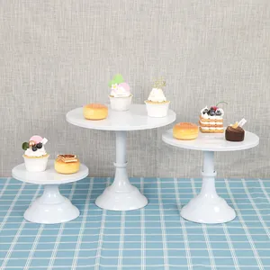 Minimalist 3-piece set of white round metal cake display stands for dessert table decoration.