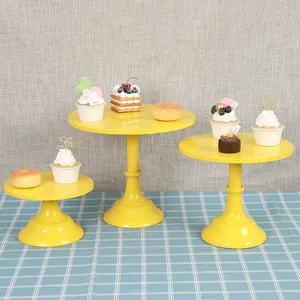 Detailed view of yellow metal cake stand set with artificial desserts