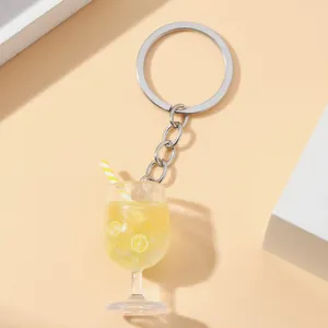 Macro view of a miniature simulation lemon juice glass keychain with a striped straw