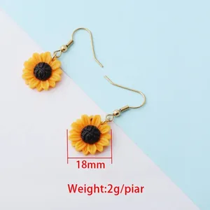 Detail showing the 18mm diameter and lightweight design of yellow sunflower earrings