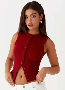 Detailed macro view of a red ribbed button-down tank top worn by a female model in studio