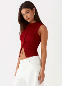 Close-up detail of a red sleeveless ribbed button-up crop top vest on a female model