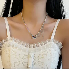 Close-up of a butterfly necklace with colorful stones and rhinestones on a model