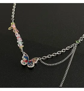 Close-up detail of Y2K style butterfly necklace featuring vibrant colorful crushed stones