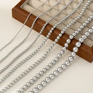 Comparison of seven sizes of silver metallic bead necklaces on a jewelry tray