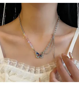 Close-up of butterfly pendant necklace with colorful crushed stones and crystals