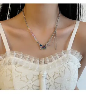 Detail shot of a y2k style colorful crushed stone butterfly necklace worn by a model
