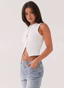 Detail view of a white sleeveless rib-knit vest with front button closure