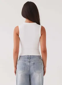 Detailed back view of a white slim-fit ribbed sleeveless tank top for women in summer.