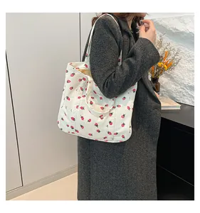 Stylish large white corduroy tote bag featuring a cute red strawberry print pattern