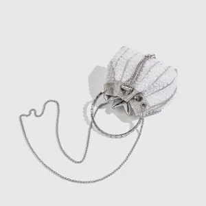 Elegant white pearl and rhinestone evening bucket bag with ring handle and chain strap.