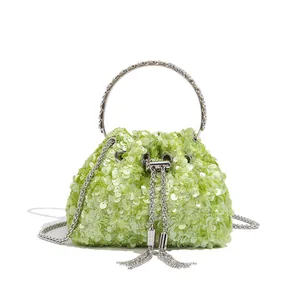 Lime green sequined bucket evening bag with rhinestone handle and metallic tassels