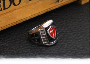 Close-up of vintage stainless steel crusader ring with red enamel cross